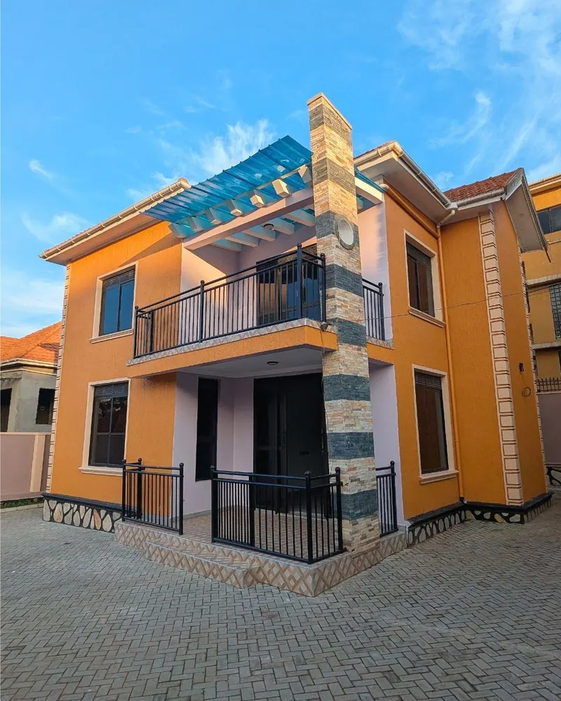 A freshly painted two-storey family home with a paved front yard